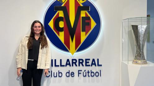 Ella in front of the Villarreal CF logo and the Europa league trophy