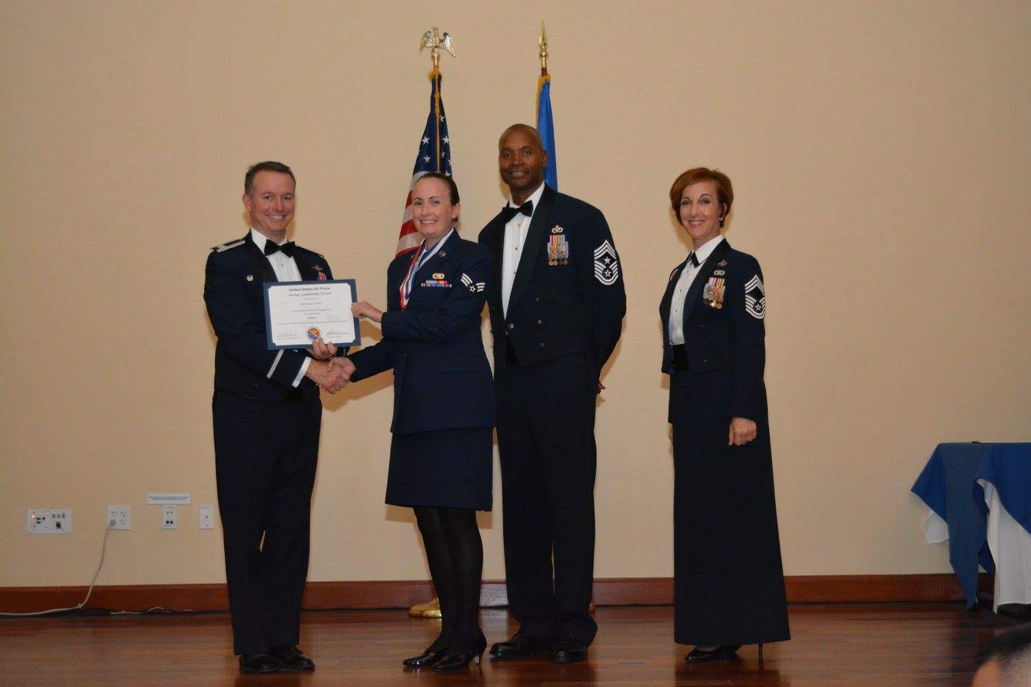 Kelsey Norris in the Air Force receives award with three colleagues