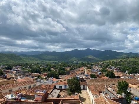 A view of house rooftops and mountains.