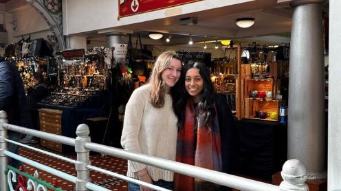 Carina and another student standing in front of a storefront in London.